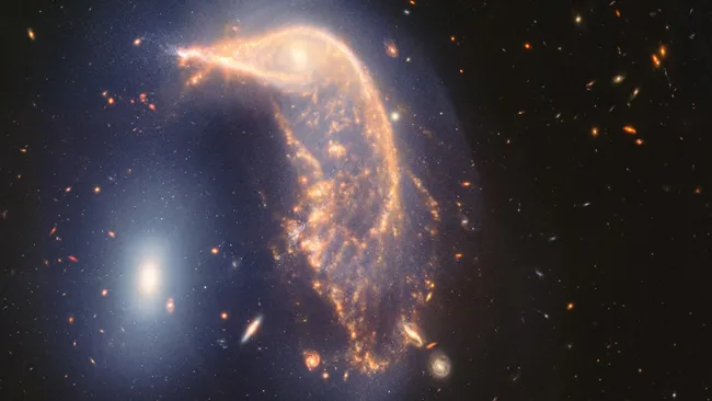 The space photo of the week shows a distorted galaxy resembling a penguin, as observed by the JWST, moving slowly towards its inevitable destruction.